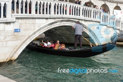 Gondolier Ferrying People In Venice Stock Photo