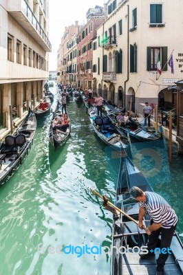 Gondoliers Ferrying Passengers In Venice Stock Photo