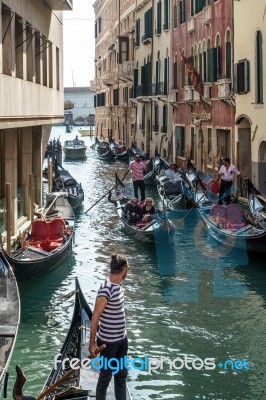 Gondoliers Ferrying Passengers In Venice Stock Photo