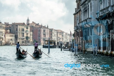 Gondoliers Ferrying People In Venice Stock Photo