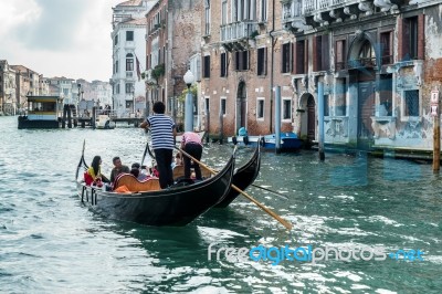 Gondoliers Ferrying People In Venice Stock Photo