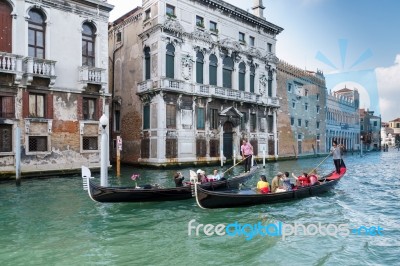 Gondoliers Ferrying People In Venice Stock Photo