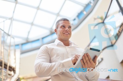 Good Looking Young Businessman With Tablet Computer In Modern Bu… Stock Photo