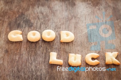 Good Luck Alphabet Biscuit On Wooden Table Stock Photo