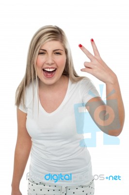 Gorgeous Blonde Girl Gesturing Victory Sign Stock Photo