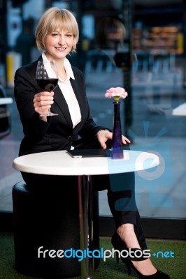 Gorgeous Corporate Woman Enjoying Red Wine Stock Photo