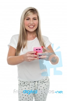 Gorgeous Girl Messaging Her Friends From Cellphone Stock Photo