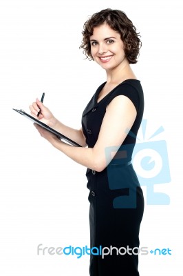 Gorgeous Young Female With A Writing Pad Stock Photo