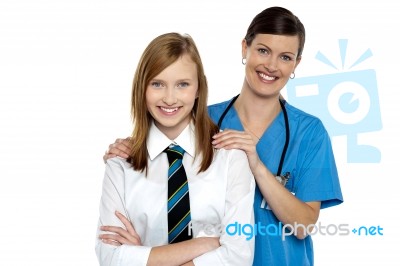 Graceful Doctor Posing With Her Teenage Patient Stock Photo