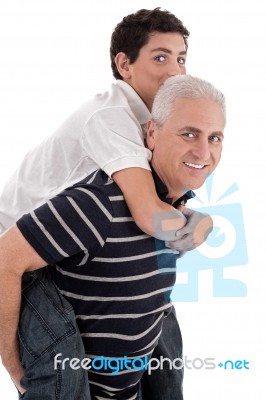 Grandfather Piggybacking His Grandson Stock Photo