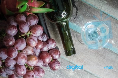 Grapes And Wine Bottles Lying Stock Photo