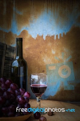 Grapes And Wine Glasses On A Wooden Stock Photo