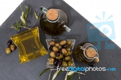 Green And Black Olives With Olive Oil Bottles Stock Photo