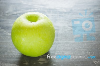 Green Apple On The Table Stock Photo