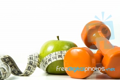 Green Apple, Tape Measure And Dumbbells Stock Photo