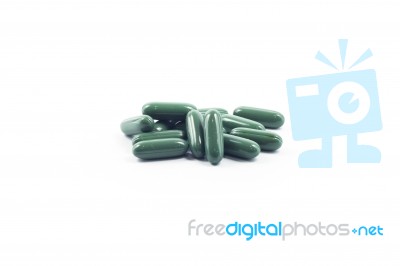 Green Capsule Pills On White Background Stock Photo