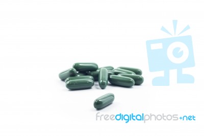 Green Capsule Pills On White Background Stock Photo