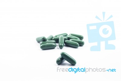 Green Capsule Pills On White Background Stock Photo