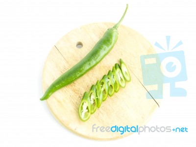 Green Chili Pepper Sliced With Raw Material On Cutting Board Stock Photo