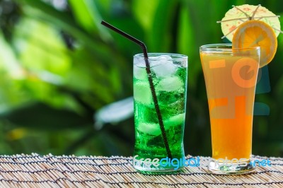 Green Fruit Soda And Orange Juice Stock Photo