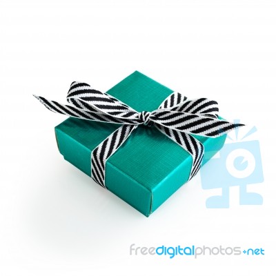 Green Gift Box With Black And White Ribbon Stock Photo