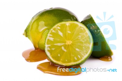 Green Limes With Honey Stock Photo