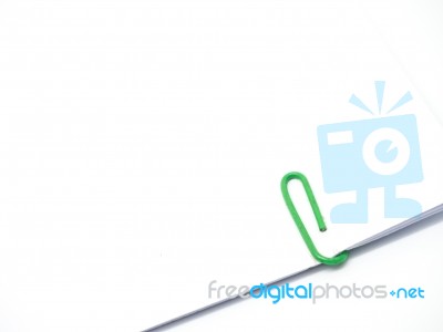 Green Paperclip Attached On White Paper Isolated Stock Photo