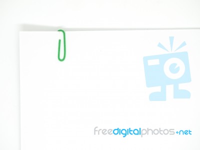 Green Paperclip Attached On White Paper Isolated Stock Photo