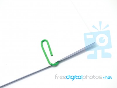 Green Paperclip Attached On White Paper Isolated Stock Photo