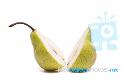 Green Pear Sliced In Half On White Stock Photo