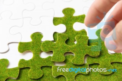 Green Puzzle Piece, Green Space Concept Stock Photo