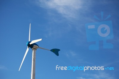 Green Renewable Energy Concept - Wind Generator Turbines On Blue… Stock Photo