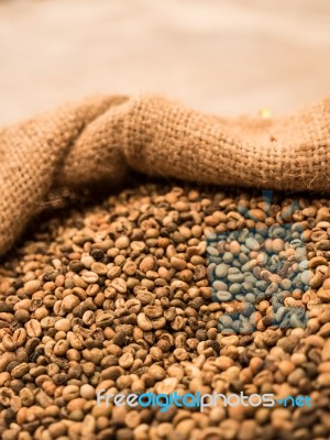 Green Unroasted Coffee Beans In Sack Stock Photo