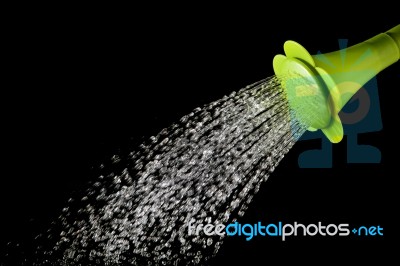 Green Watering Can Pouring Water With High Speed Shutter Isolated On Black Stock Photo