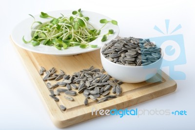 Green Young Sunflower Sprouts On Salad Plate And Sunflower Seeds… Stock Photo