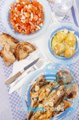 Grilled European Seabass With Potato And Tomato Salad Stock Photo