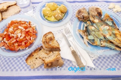 Grilled European Seabass With Potato And Tomato Salad Stock Photo