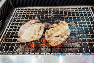 Grilling Pork On Fire Stock Photo