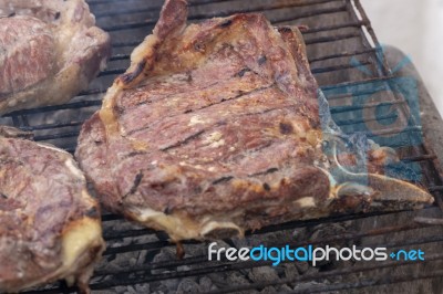 Grilling Steak On The Barbecue Stock Photo