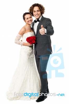 Groom With His Bride Showing Thumbs Up Sign Stock Photo