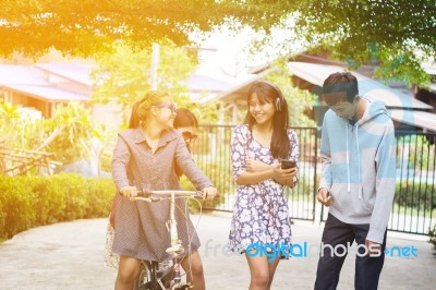 Group Of Asian Teenager Walking In The Park  Stock Photo