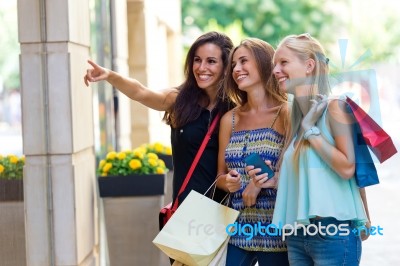 Group Of Beautiful Girls Looking At The Shop Window Stock Photo