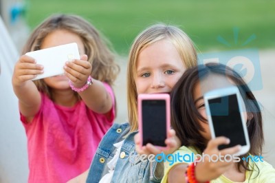 Group Of Childrens Taking A Selfie In The Park Stock Photo