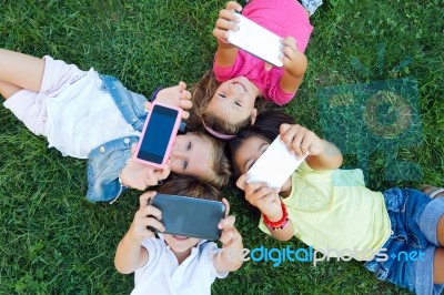 Group Of Childrens Taking A Selfie In The Park Stock Photo