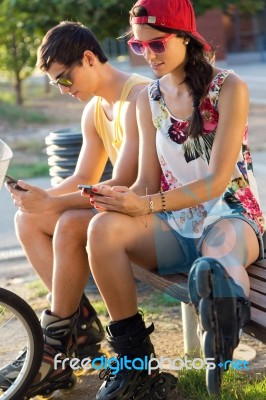 Group Of Friends Texting With Their Smart Phones In The Park Stock Photo