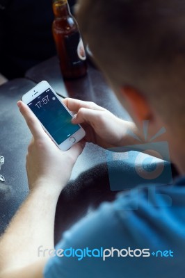 Group Of Friends Using Mobile Phone In Cafe Stock Photo