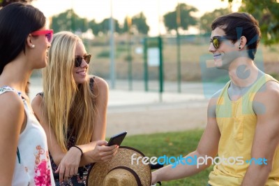 Group Of Friends With Roller Skates And Bike Riding In The Park Stock Photo