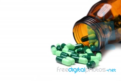 Group Of Green Capsule Medicine In Bottle Stock Photo