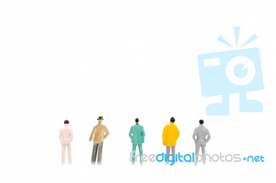 Group Of Miniature Businessman On White Background Stock Photo