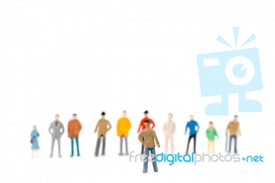 Group Of Miniature People Standing On White Background Stock Photo